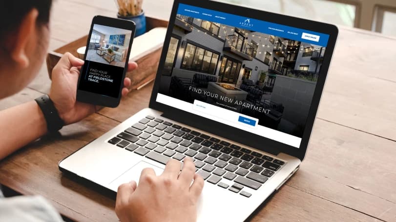 Man on a laptop with a smart phone